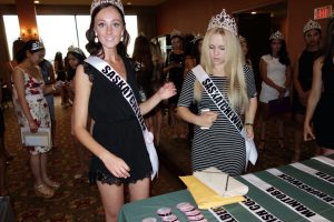 Miss Teen Saskatoon at registration table opening night